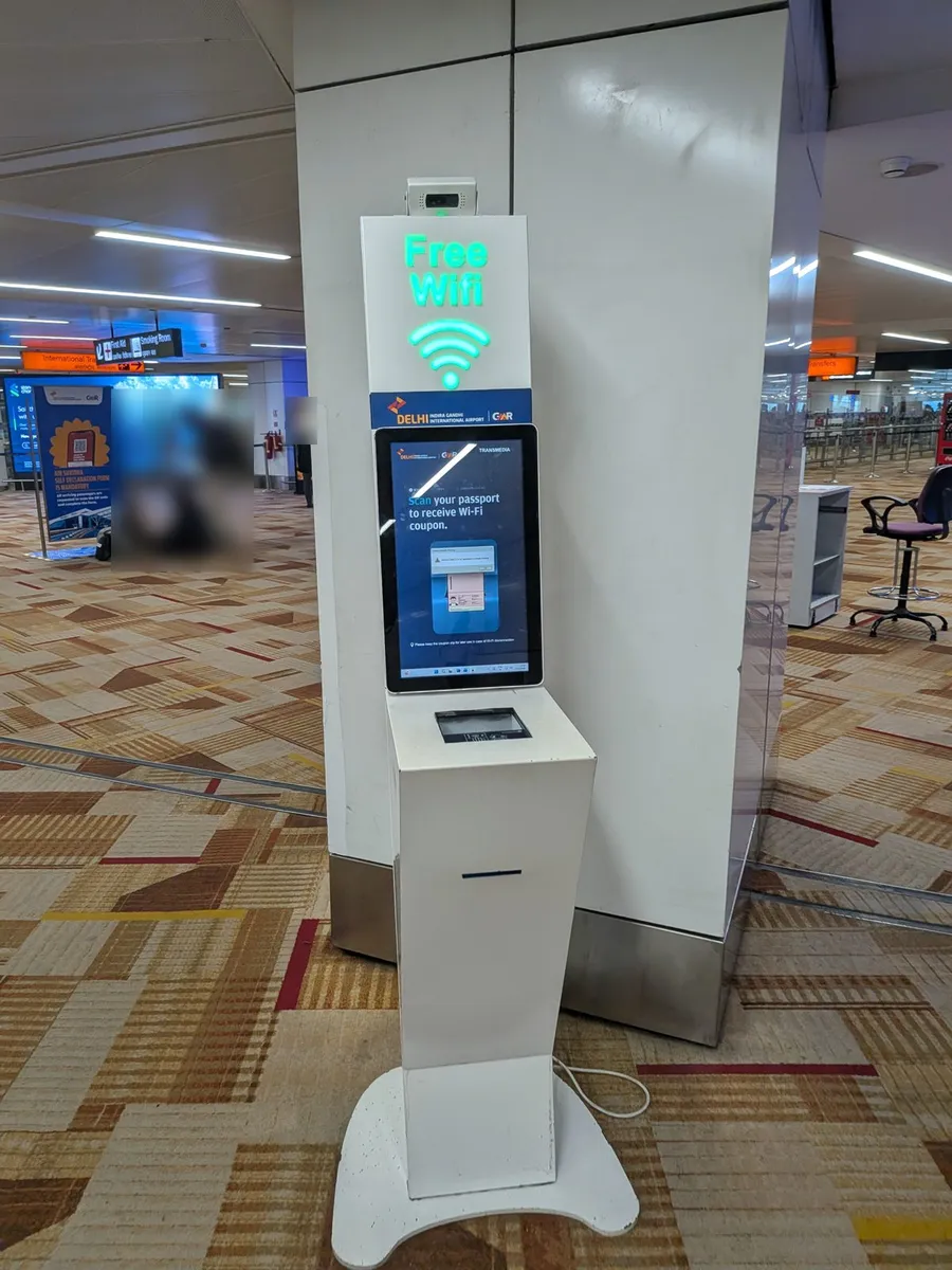 Free Wi-Fi kiosk at Delhi T3 with the screen reading Scan your passport to receive Wi-Fi coupon