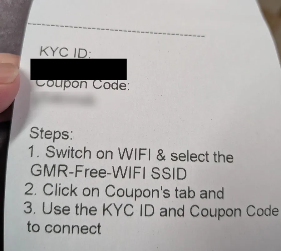 Printed Delhi airport Wi-Fi coupon slip with the KYC ID and coupon code hidden